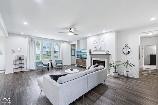 14458 Carlow Run, Carmel, IN 46074 - living room with dark wood finished floors, a ceiling fan, recessed lighting, a tiled fireplace, and baseboards