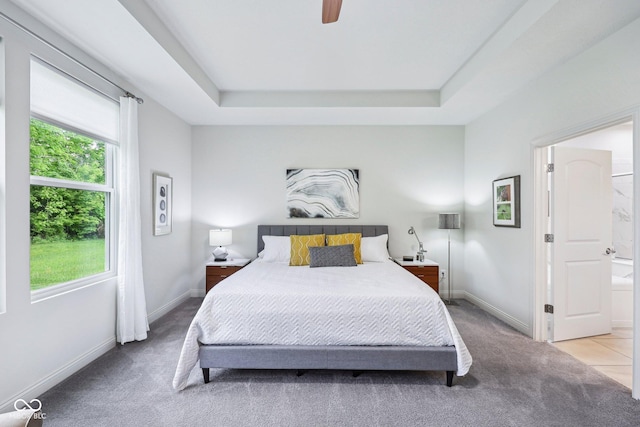 14458 Carlow Run, Carmel, IN 46074 - carpeted bedroom featuring multiple windows, a tray ceiling, baseboards, and a ceiling fan
