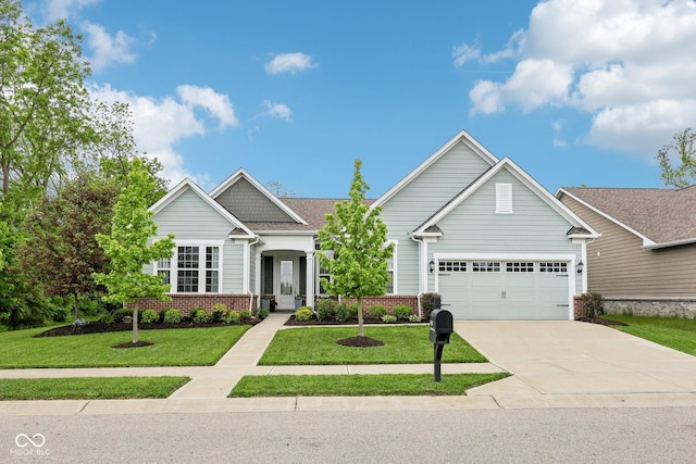 14458 Carlow Run, Carmel, IN 46074 - view of front facade featuring driveway, a front lawn, brick siding, and a garage