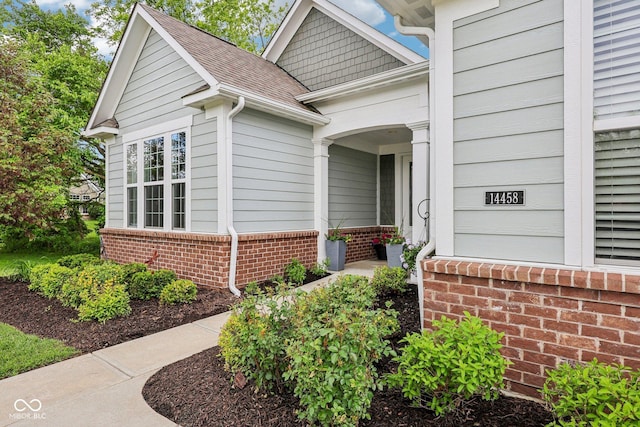 14458 Carlow Run, Carmel, IN 46074 - view of exterior entry with brick siding and roof with shingles
