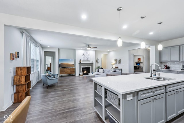 14458 Carlow Run, Carmel, IN 46074 - kitchen with gray cabinets, a sink, a ceiling fan, decorative light fixtures, and recessed lighting