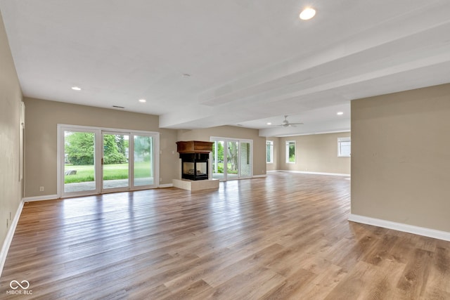 6610 Royal Oakland Dr, Indianapolis, IN 46236 - unfurnished living room with baseboards, recessed lighting, light wood-style floors, a multi sided fireplace, and ceiling fan