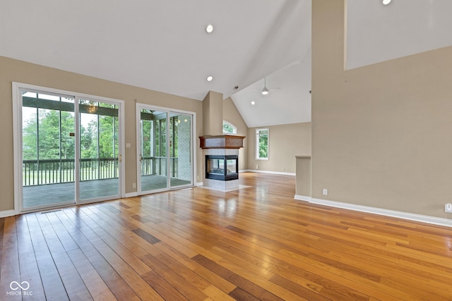 6610 Royal Oakland Dr, Indianapolis, IN 46236 - unfurnished living room with light wood-type flooring, baseboards, high vaulted ceiling, a fireplace, and recessed lighting