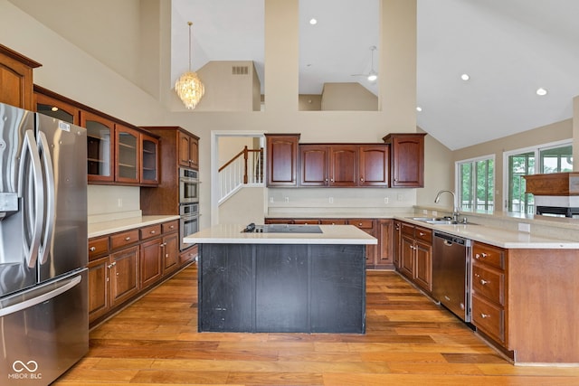 6610 Royal Oakland Dr, Indianapolis, IN 46236 - kitchen with stainless steel appliances, a sink, high vaulted ceiling, light countertops, and light wood-style floors