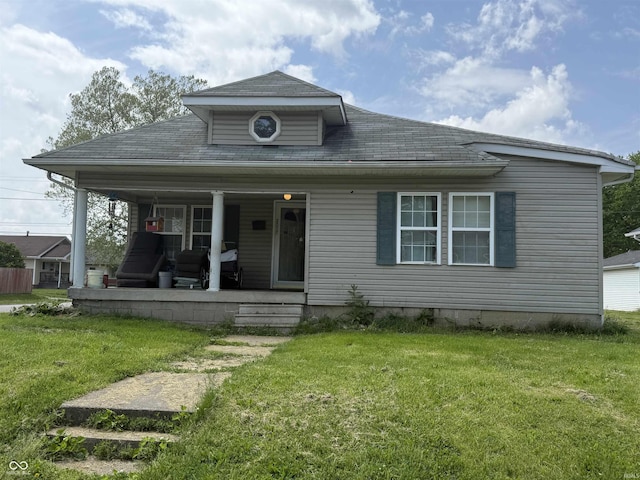 2017 Cherrywood Ave, New Castle, IN 47362 - bungalow featuring a front lawn, roof with shingles, and covered porch