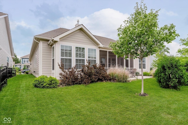 15593 Marsden Dr, Westfield, IN 46074 - back of property with a sunroom, a chimney, and a shingled roof