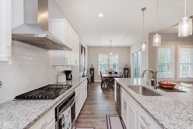 15593 Marsden Dr, Westfield, IN 46074 - kitchen featuring wall chimney exhaust hood, stainless steel appliances, dark wood-type flooring, decorative backsplash, and white cabinetry