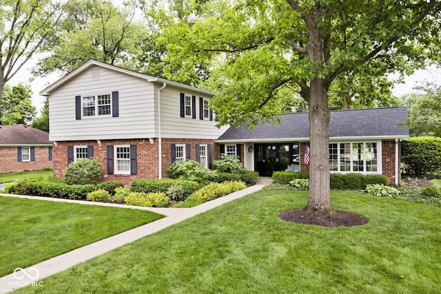 6115 E 65th Pl, Indianapolis, IN 46220 - view of front facade with brick siding and a front lawn