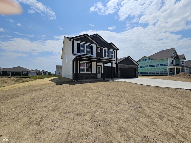 2271 Oakmont Dr, Plainfield, IN 46168 - view of front of property featuring concrete driveway, covered porch, a garage, a residential view, and brick siding
