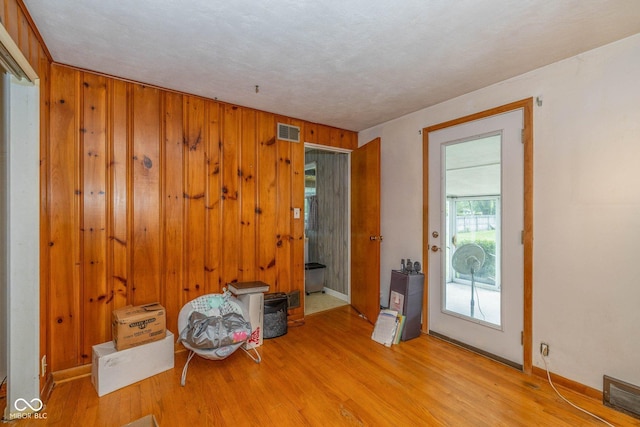 2445 S Bolton Ave, Indianapolis, IN 46203 - unfurnished room featuring wood finished floors, wood walls, and baseboards
