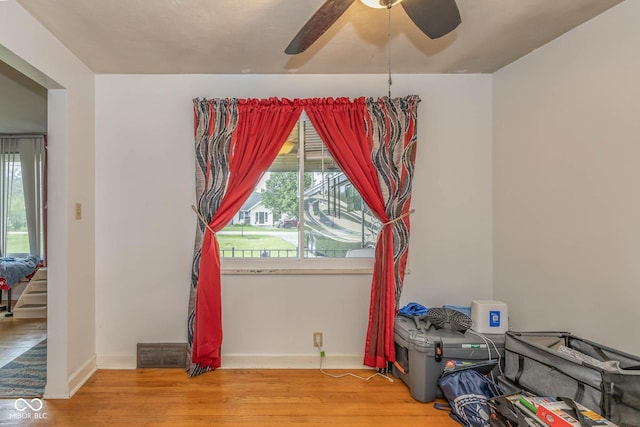 2445 S Bolton Ave, Indianapolis, IN 46203 - empty room featuring light wood-style flooring, plenty of natural light, baseboards, and ceiling fan