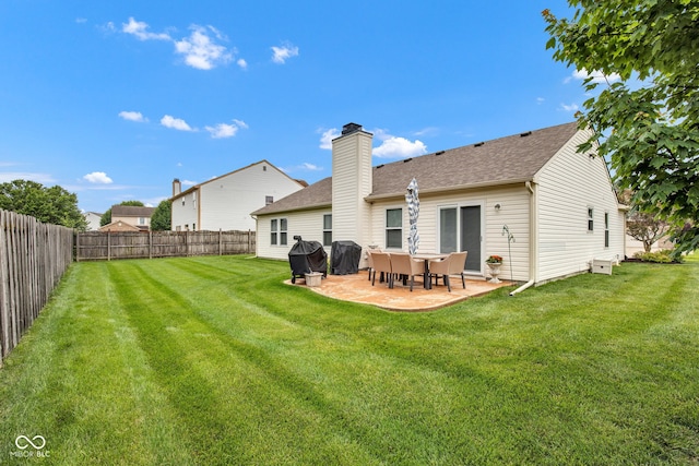 2163 Bradford Trace Blvd, Indianapolis, IN 46229 - back of house with a patio, a fenced backyard, roof with shingles, and a chimney