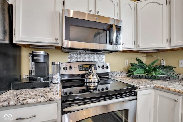 2163 Bradford Trace Blvd, Indianapolis, IN 46229 - kitchen featuring appliances with stainless steel finishes, white cabinets, and light stone counters
