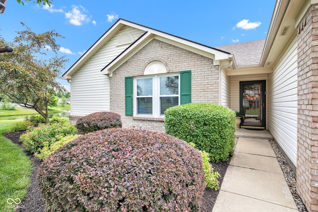 2163 Bradford Trace Blvd, Indianapolis, IN 46229 - view of exterior entry featuring brick siding and a shingled roof
