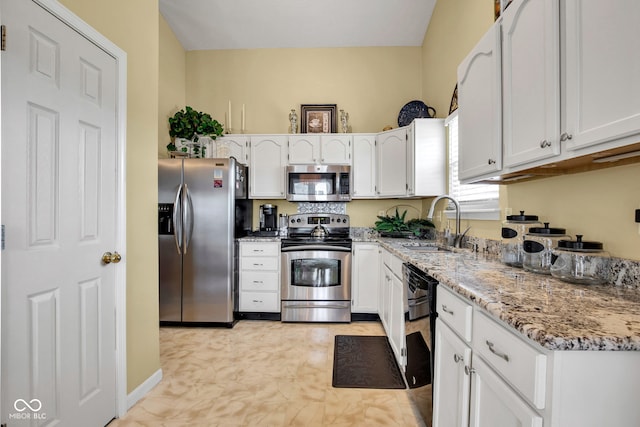 2163 Bradford Trace Blvd, Indianapolis, IN 46229 - kitchen with stainless steel appliances, white cabinetry, and light stone counters
