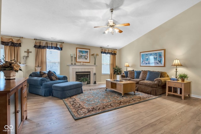 2163 Bradford Trace Blvd, Indianapolis, IN 46229 - living room featuring plenty of natural light, light wood-style floors, ceiling fan, a tiled fireplace, and vaulted ceiling