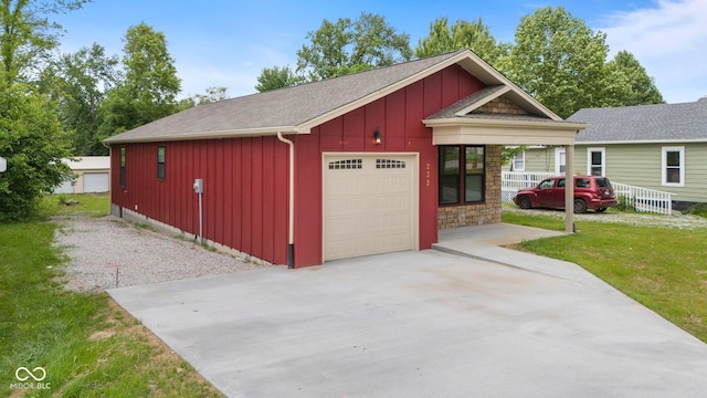 232 E Main St, Austin, IN 47102 - view of front of property with board and batten siding, driveway, a front lawn, a shingled roof, and a garage