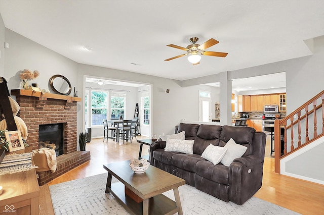 7312 Drum Castle Ct, Indianapolis, IN 46259 - living room featuring a ceiling fan, light wood finished floors, a brick fireplace, baseboards, and recessed lighting