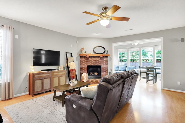 7312 Drum Castle Ct, Indianapolis, IN 46259 - living area featuring a ceiling fan, light wood-type flooring, baseboards, and a fireplace