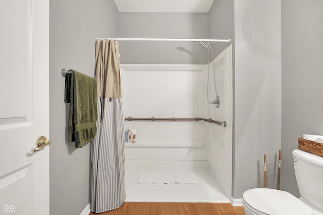 7312 Drum Castle Ct, Indianapolis, IN 46259 - bathroom featuring a shower stall, wood finished floors, toilet, and baseboards