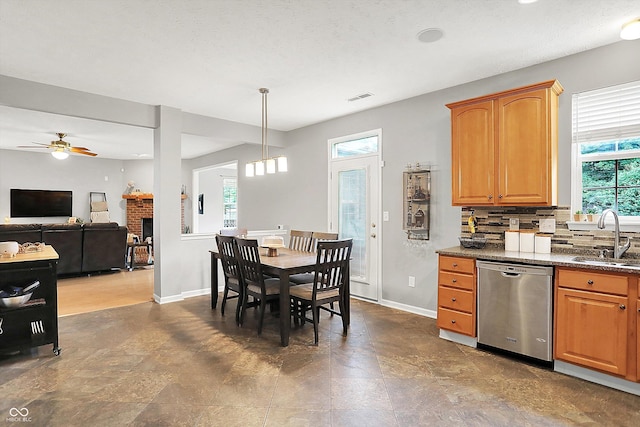 7312 Drum Castle Ct, Indianapolis, IN 46259 - kitchen with dishwasher, a sink, baseboards, ceiling fan, and backsplash