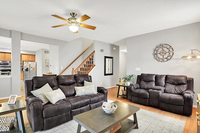 7312 Drum Castle Ct, Indianapolis, IN 46259 - living room with light wood-style floors, stairway, a ceiling fan, and baseboards