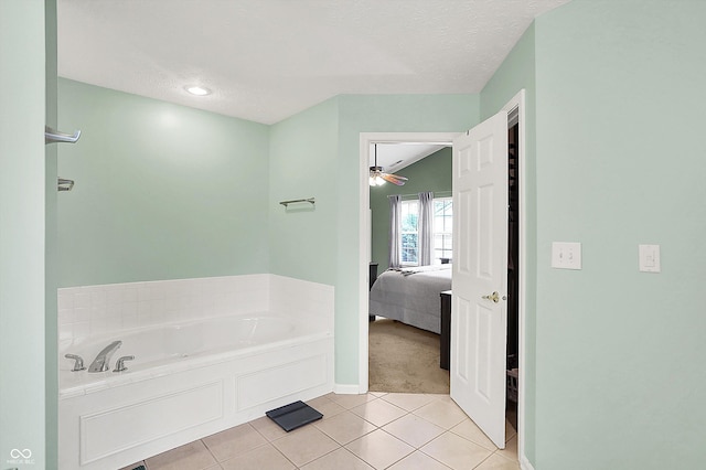 7312 Drum Castle Ct, Indianapolis, IN 46259 - full bathroom featuring ensuite bathroom, a bath, tile patterned flooring, a textured ceiling, and baseboards