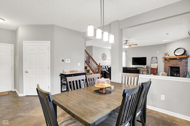 7312 Drum Castle Ct, Indianapolis, IN 46259 - dining area featuring ceiling fan, stairs, a brick fireplace, and baseboards
