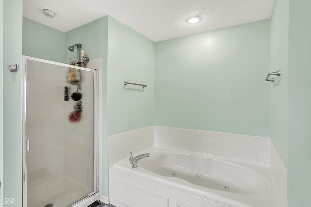 7312 Drum Castle Ct, Indianapolis, IN 46259 - full bathroom featuring a stall shower, a tub with jets, and a textured ceiling