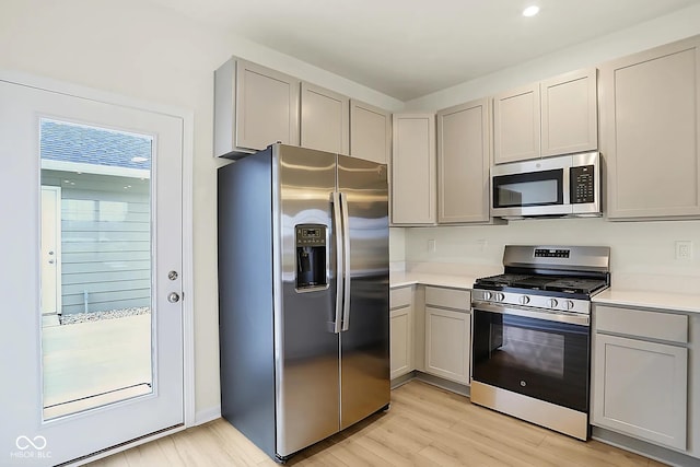 3927 Wren Dr, Brownsburg, IN 46112 - kitchen featuring appliances with stainless steel finishes, gray cabinetry, light wood-style floors, light countertops, and recessed lighting