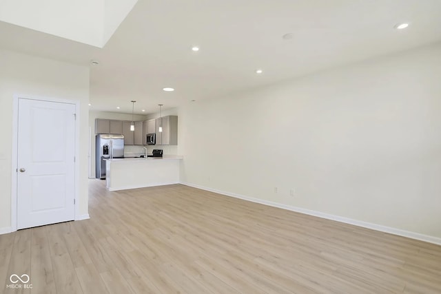 3927 Wren Dr, Brownsburg, IN 46112 - unfurnished living room featuring light wood-type flooring, baseboards, and recessed lighting
