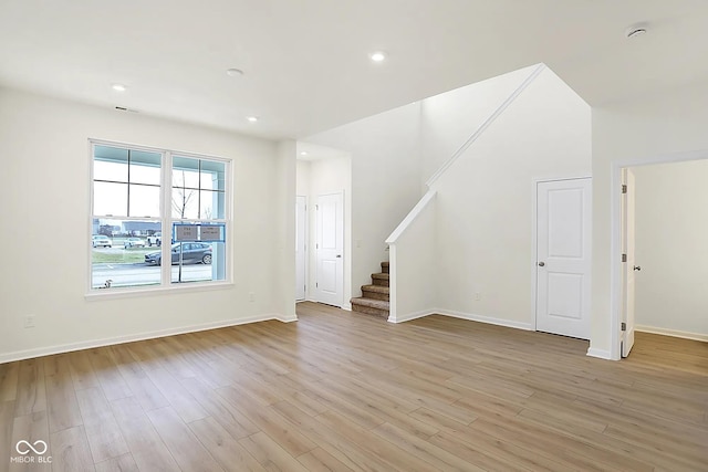 3927 Wren Dr, Brownsburg, IN 46112 - unfurnished living room featuring stairway, light wood finished floors, recessed lighting, and baseboards