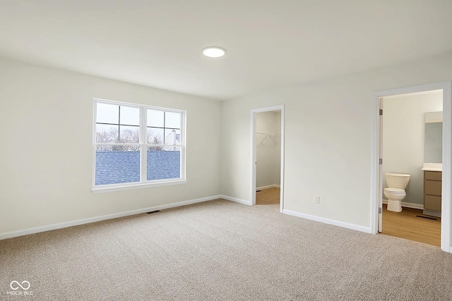 3927 Wren Dr, Brownsburg, IN 46112 - unfurnished bedroom featuring carpet floors, a spacious closet, baseboards, a closet, and connected bathroom