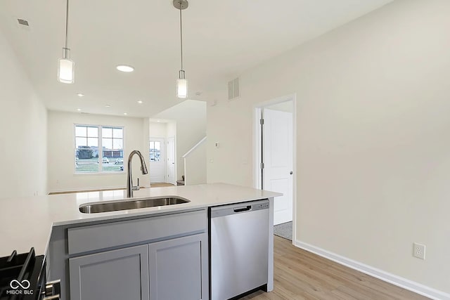 3927 Wren Dr, Brownsburg, IN 46112 - kitchen featuring dishwasher, a sink, light wood-type flooring, hanging light fixtures, and recessed lighting