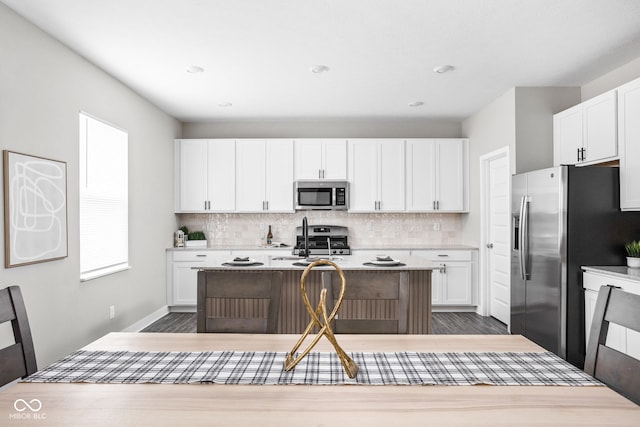 11588 Brooks Farm Blvd, Noblesville, IN 46060 - kitchen featuring appliances with stainless steel finishes, tasteful backsplash, dark wood-type flooring, white cabinetry, and recessed lighting