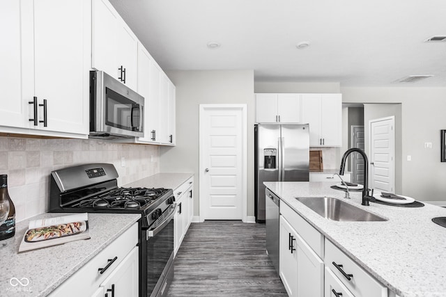 11588 Brooks Farm Blvd, Noblesville, IN 46060 - kitchen featuring appliances with stainless steel finishes, tasteful backsplash, dark wood finished floors, and light stone counters