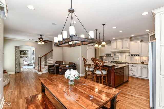 13909 Waterway Blvd, Fishers, IN 46040 - dining space with stairs, a ceiling fan, arched walkways, light wood-style flooring, and recessed lighting