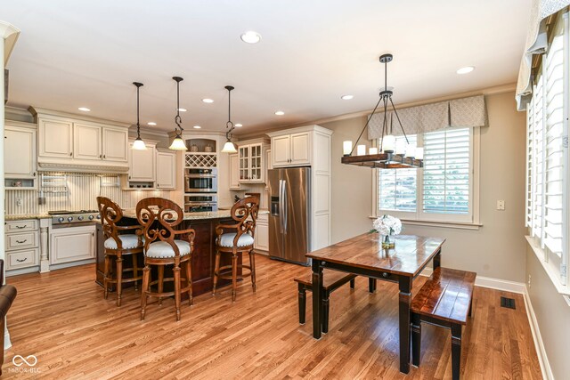 13909 Waterway Blvd, Fishers, IN 46040 - dining area with light wood-type flooring, recessed lighting, baseboards, a chandelier, and crown molding