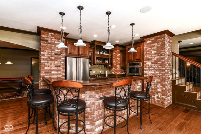 13909 Waterway Blvd, Fishers, IN 46040 - indoor wet bar with appliances with stainless steel finishes, dark wood-type flooring, stairs, hanging light fixtures, and recessed lighting