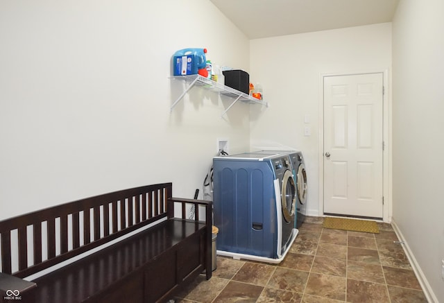 6110 Pelican Ln, Columbus, IN 47201 - laundry room with washer and dryer, baseboards, and stone finish flooring