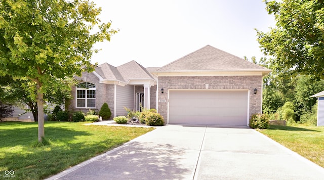 6110 Pelican Ln, Columbus, IN 47201 - ranch-style home with driveway, a front yard, a garage, and a shingled roof