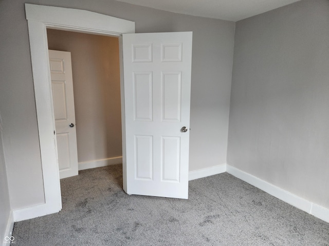 323-325 N Gladstone Ave, Indianapolis, IN 46201 - unfurnished bedroom featuring carpet and baseboards