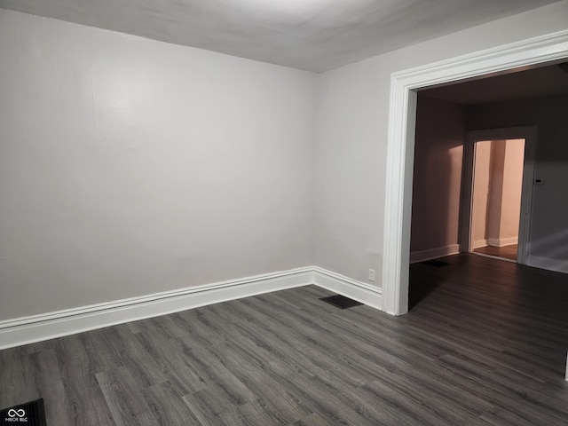 323-325 N Gladstone Ave, Indianapolis, IN 46201 - empty room featuring dark wood finished floors and baseboards