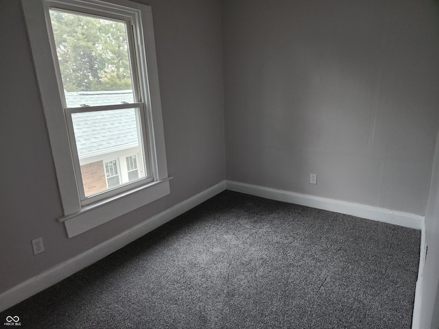 323-325 N Gladstone Ave, Indianapolis, IN 46201 - empty room featuring dark carpet, healthy amount of natural light, and baseboards