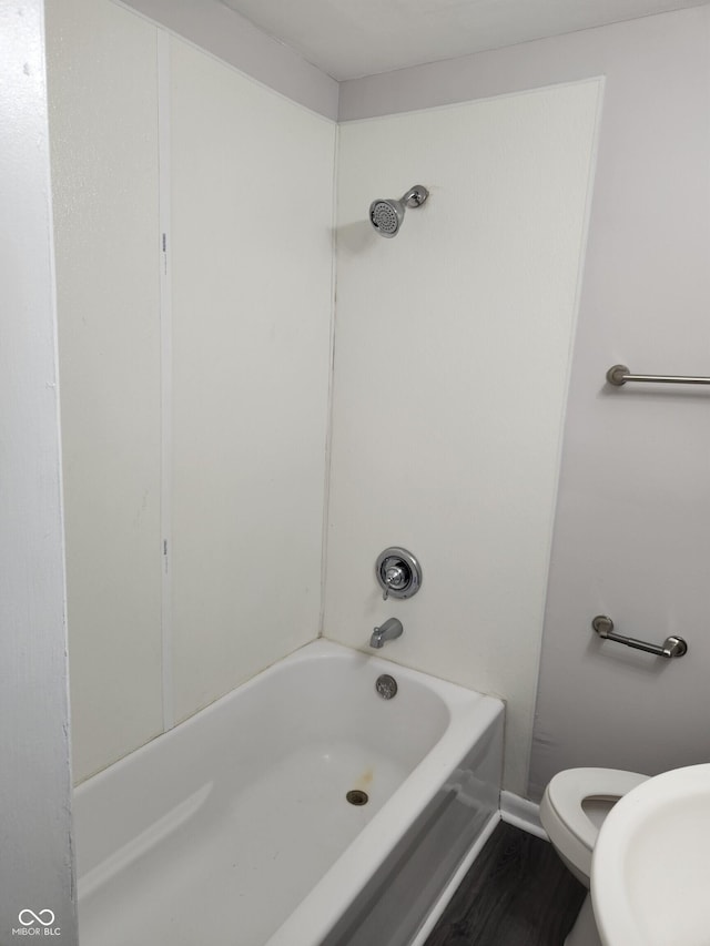 323-325 N Gladstone Ave, Indianapolis, IN 46201 - bathroom featuring toilet, tub / shower combination, wood finished floors, and a sink