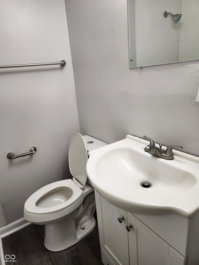323-325 N Gladstone Ave, Indianapolis, IN 46201 - bathroom with vanity, toilet, and wood finished floors