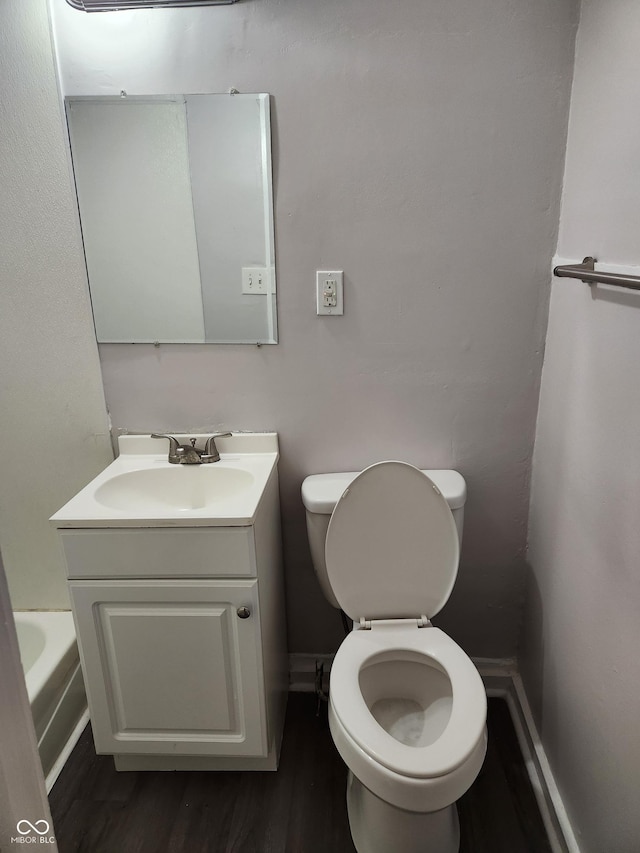 323-325 N Gladstone Ave, Indianapolis, IN 46201 - bathroom with toilet, wood finished floors, vanity, and a bath