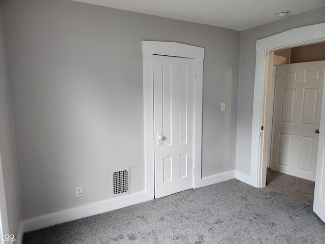 323-325 N Gladstone Ave, Indianapolis, IN 46201 - unfurnished bedroom with carpet floors and baseboards