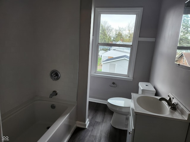 323-325 N Gladstone Ave, Indianapolis, IN 46201 - bathroom with toilet, vanity, wood finished floors, bathtub / shower combination, and baseboards