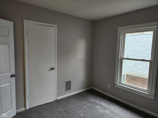 323-325 N Gladstone Ave, Indianapolis, IN 46201 - spare room with plenty of natural light, dark carpet, and baseboards